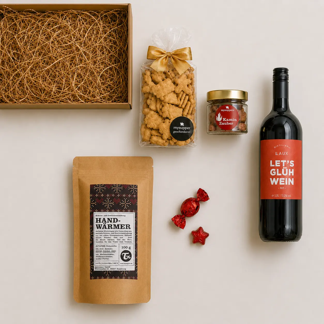 Inhalt des Glühwein-Geschenksets: Glühwein, Kräutertee Handwärmer, Spekulatius und Kaminzauber-Bonbons